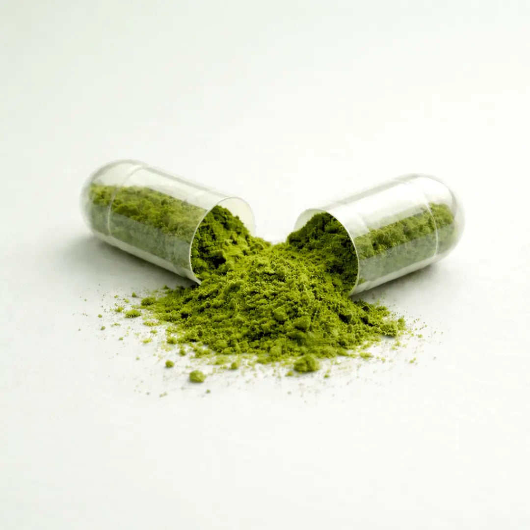 One capsule of Glow by ARYA LAB with green powder spilling out on a white background