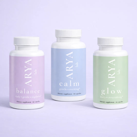 Three ARYA supplement bottles labeled 'balance', 'calm', and 'glow' on a light purple background.